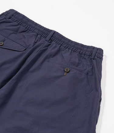 UNIVERSAL WORKS SHORT PLISSÉ TRACK 34151 POPELINE PEACHED NAVY - Shoelosophy