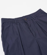UNIVERSAL WORKS SHORT PLISSÉ TRACK 34151 POPELINE PEACHED NAVY - Shoelosophy