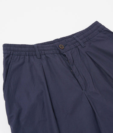 UNIVERSAL WORKS SHORT PLISSÉ TRACK 34151 POPELINE PEACHED NAVY - Shoelosophy